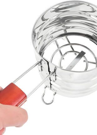 Stainless steel charcoal holder with wooden handle, held by a hand